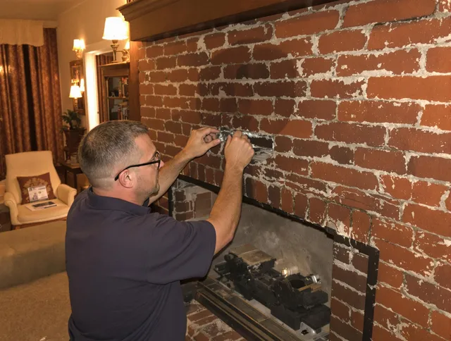 Warren Chimney Sweep expert fixing a fireplace in Warren, RI